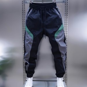 Men'S Long Pants, Casual Pants, Sports Pants, And Trendy Jogger Pants in Black, Gray, And Green Color-Blocking, Featuring a Bold And Unique Design. The Elastic Waistband with Drawstring Allows for Easy Wear And Removal, While The Tapered Fit Gives a